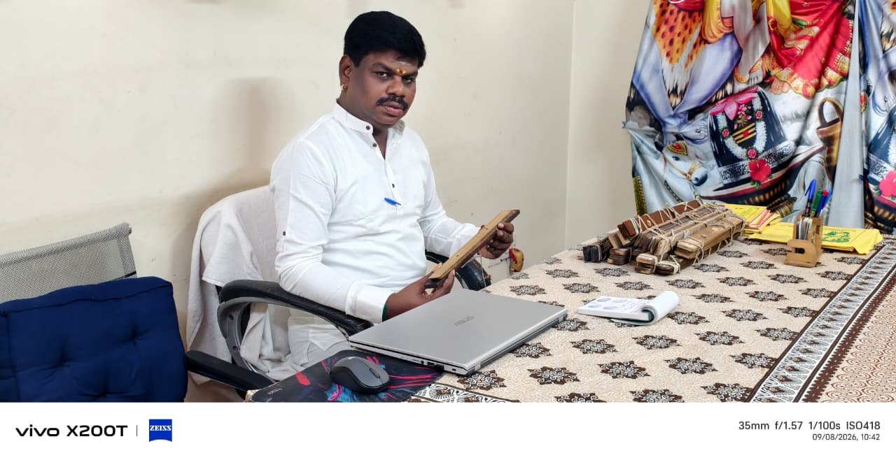 Guruji holding a palm leaf manuscript