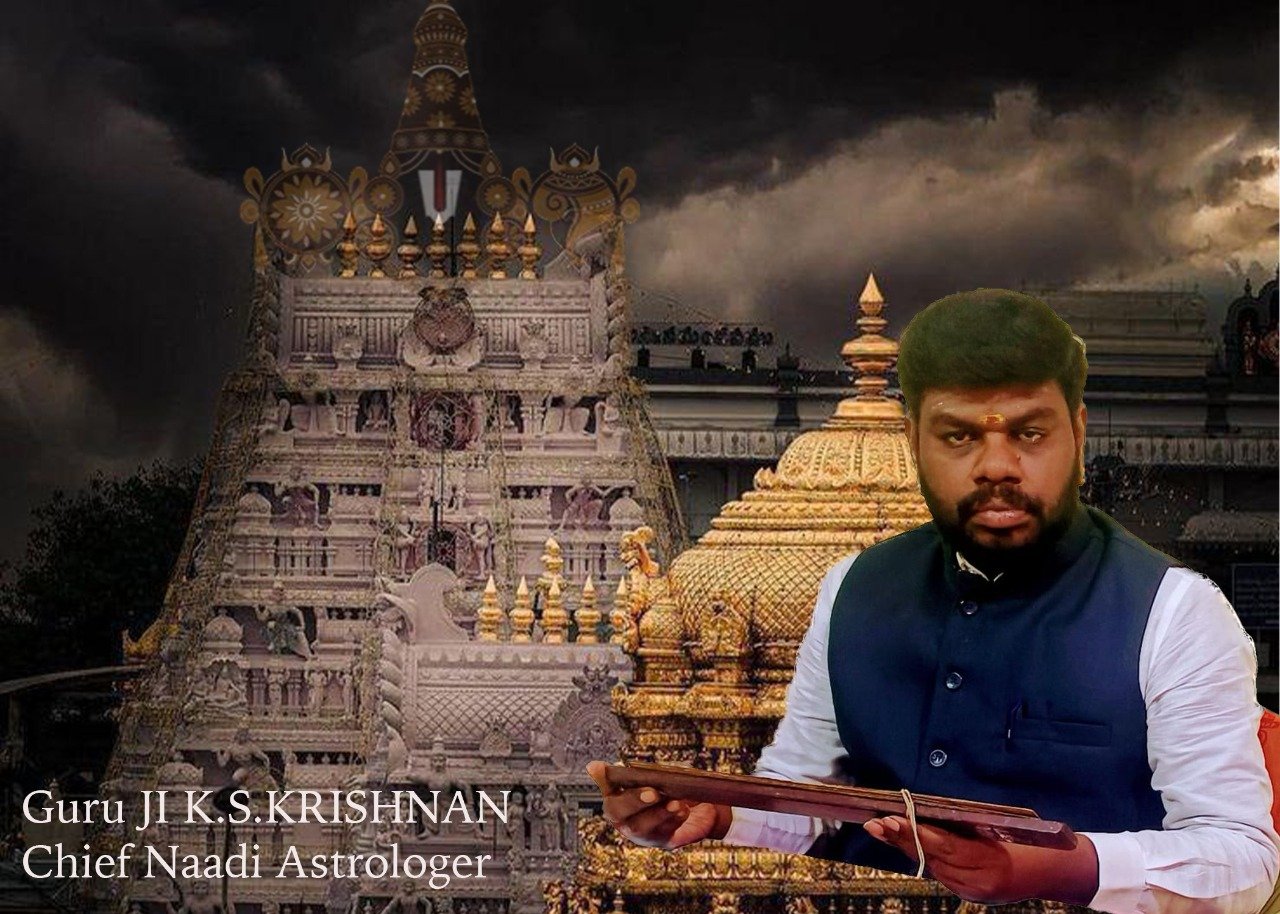 Guruji K.S. Krishnan before a temple gopuram holding a palm leaf